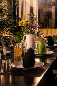 a table with plates of food and flowers on it at Kandyan Lounge in Kiribatkumbura