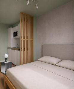 a bedroom with a bed and a wooden cabinet at smart studios - by kalm stay in Munich
