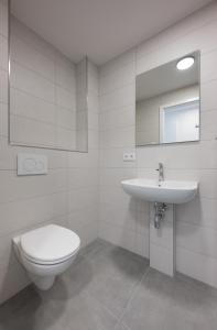 a white bathroom with a toilet and a sink at smart studios - by kalm stay in Munich