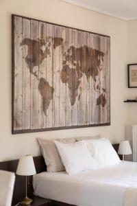 a bedroom with a map of the world on the wall at Naria Home by A&D Properties in Porto Rafti