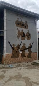 a mural of people on a wall on a building at Elegance hotel in Ijaiye
