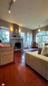 a living room with a bed and a fireplace at Suites Santo Domingo in San Miguel de Allende