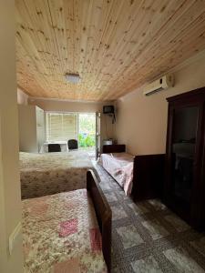 a bedroom with two beds and a couch in it at Kobuleti Central in Kobuleti
