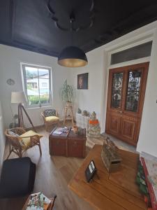 a living room with a table and a wooden door at Villa Amarinis in Saint-Amarin