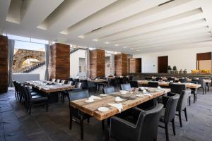 a dining room with wooden tables and chairs at La Purificadora, Puebla, a Member of Design Hotels in Puebla