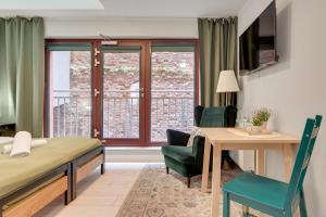 a hotel room with a bed and a table and chairs at WaterLane Island Hostel&Apartments in Gdańsk
