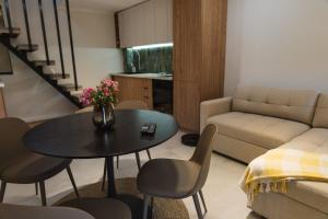 a living room with a table and a couch at Villa ARTÉ in Shabla