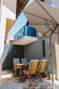 a patio with a table and chairs and a balcony at Villa ARTÉ in Shabla