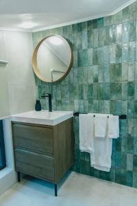 a bathroom with a sink and a mirror and towels at Villa ARTÉ in Shabla +12 photos