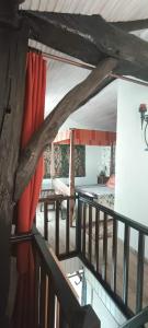a view of a room with red curtains on a balcony at La Fleur de Lys in Moulins