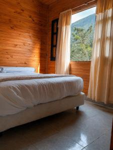 a bedroom with a bed and a large window at Complejo La Cascada San Javier in San Javier +34 photos
