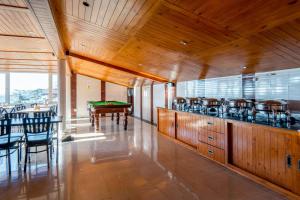 a dining room with a bar and a pool table at Hotel Windsor in Shimla