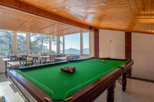 a pool table in a large room with a pool table at Hotel Windsor in Shimla