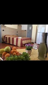 a table with a bunch of fruit and a bottle of wine at B&B Florida sul mare via faro 30 in Capo Rizzuto