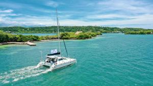 a boat in a large body of water at Tiny Village Cartagena Boutique Resort in Tierra Bomba +92 photos