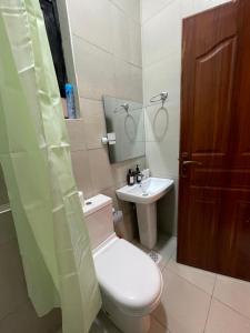 a bathroom with a toilet and a sink at Tulia, Anchor in Ruaka