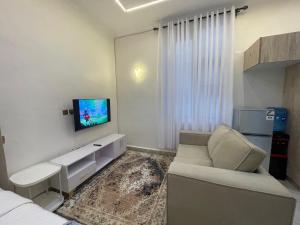 a living room with a couch and a tv at Tulia, Anchor in Ruaka