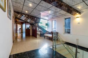 a hallway with a glass staircase and a lobby at Hotel Windsor in Shimla
