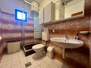 a bathroom with a toilet and a sink at Vodice Center Apartments in Vodice +23 photos
