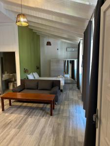a living room with a couch and a bed at Bianco Boutique in Parga