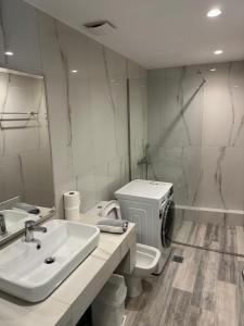 a bathroom with a sink and a toilet and a mirror at Bianco Boutique in Parga