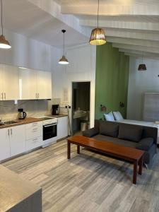 a living room with a couch and a table at Bianco Boutique in Parga +6 photos