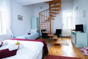 a room with two beds and a spiral staircase at Clermont Sinaia in Sinaia +116 photos