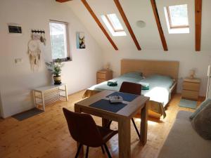 a bedroom with a bed and a table and chairs at Studioapartment Taiga in Grabovac