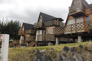 a row of houses on top of a hill at Mount House Lodge in Guano
