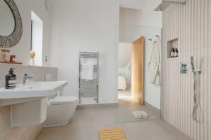 a bathroom with a sink and a toilet and a shower at Silvermere in Warmwell +56 photos