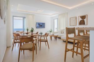 a living room with a table and chairs and a couch at Alsalos Villas in Amoopi