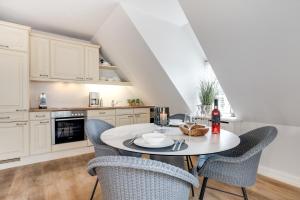 a kitchen with a table and chairs in a room at Seestern Keitum in Keitum +17 photos
