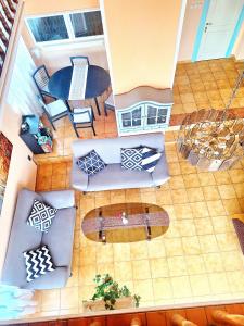 an overhead view of a living room with a surfboard at Sylvia Apartman in Balatonalmádi