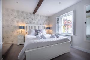 a bedroom with a white bed and a window at Ross Cottage in Hawkshead