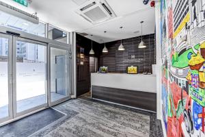 an office lobby with a reception counter and a window at Heeton Concept Hotel - City Centre Liverpool in Liverpool