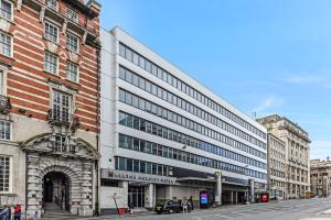 a large building on a city street with buildings at Heeton Concept Hotel - City Centre Liverpool in Liverpool