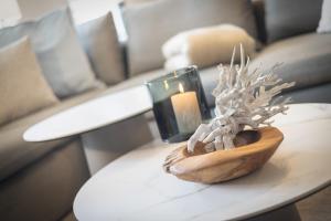 a table with a candle and a vase on it at Strandkrabbe in Keitum