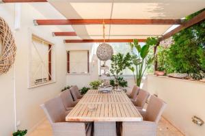 a patio with a wooden table and chairs at Luxury Apartment with Pool in Pallini