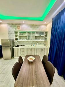 a kitchen with a wooden table and a blue ceiling at شاليهات سكون الغروب in Taif