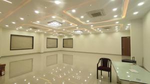 a meeting room with a table and a chair at Harsh Pushp Garden in Raipur