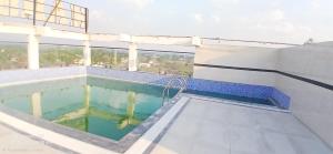 a swimming pool on the roof of a building at Harsh Pushp Garden in Raipur +13 photos