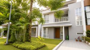 an exterior view of a white building with trees at SleepRest @ The Home Shoutlink in Nagoya