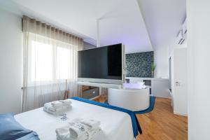 a bedroom with a bed with a tv on it at Bed&Dreams con Jacuzzi in Bergamo +30 photos