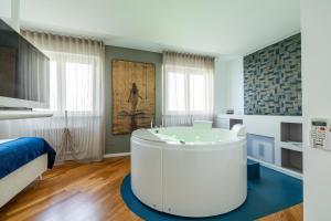 a bathroom with a tub in the middle of a room at Bed&Dreams con Jacuzzi in Bergamo