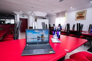 a laptop sitting on a red table in a restaurant at Clermont Sinaia in Sinaia