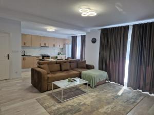 a living room with a couch and a table at Apartamente 2026 in Fălticeni