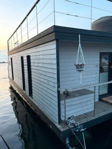 a house on a dock on the water at Knobis DreamPlace in Heiligenhafen +3 photos