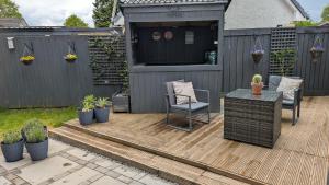 a patio with a table and chairs and a building at Harestanes Hideaway in Kirkintilloch