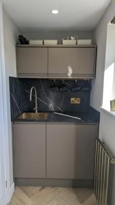 a kitchen with a sink and a counter top at Harestanes Hideaway in Kirkintilloch