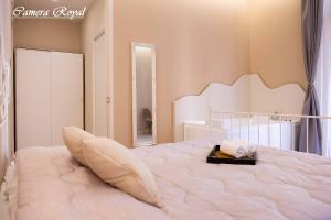 a bedroom with a large white bed with a mirror at Dharma Luxury Room in La Spezia
